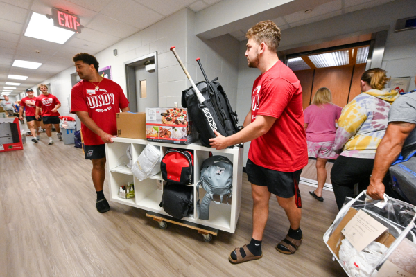 students carrying res hall room supplies