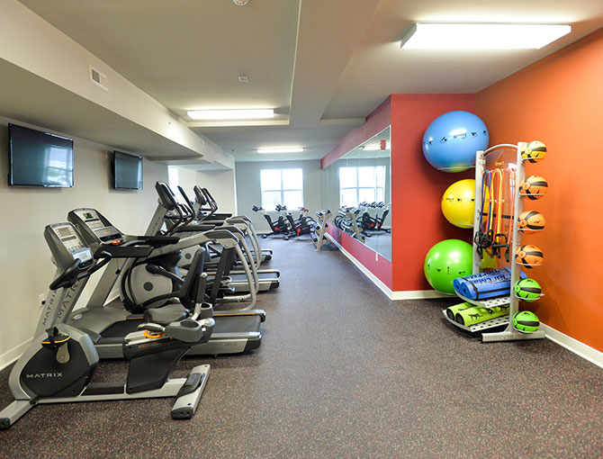 fitness center with several exercise equipment