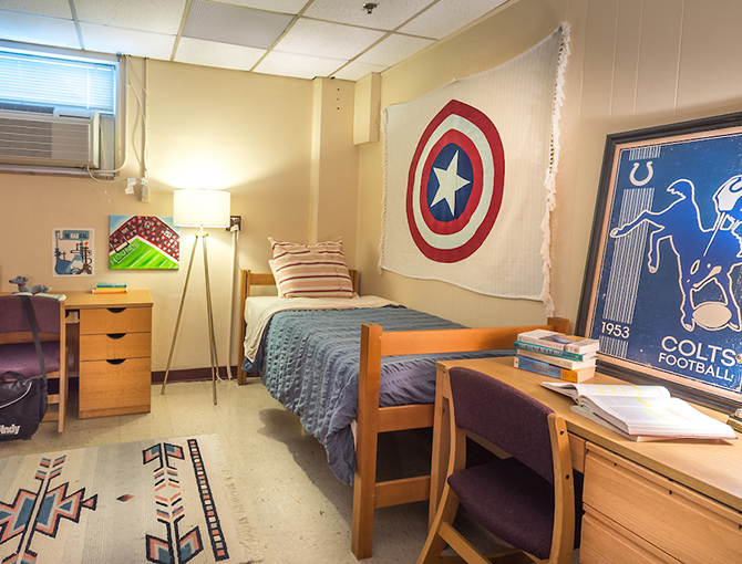 a corner bed with two desks perpendicular to each other