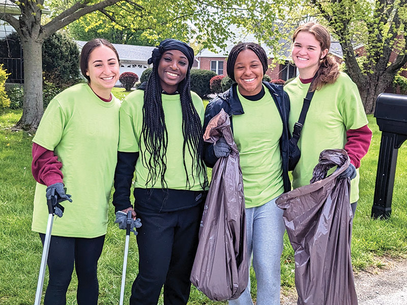 students holding trash bags during the cleanup